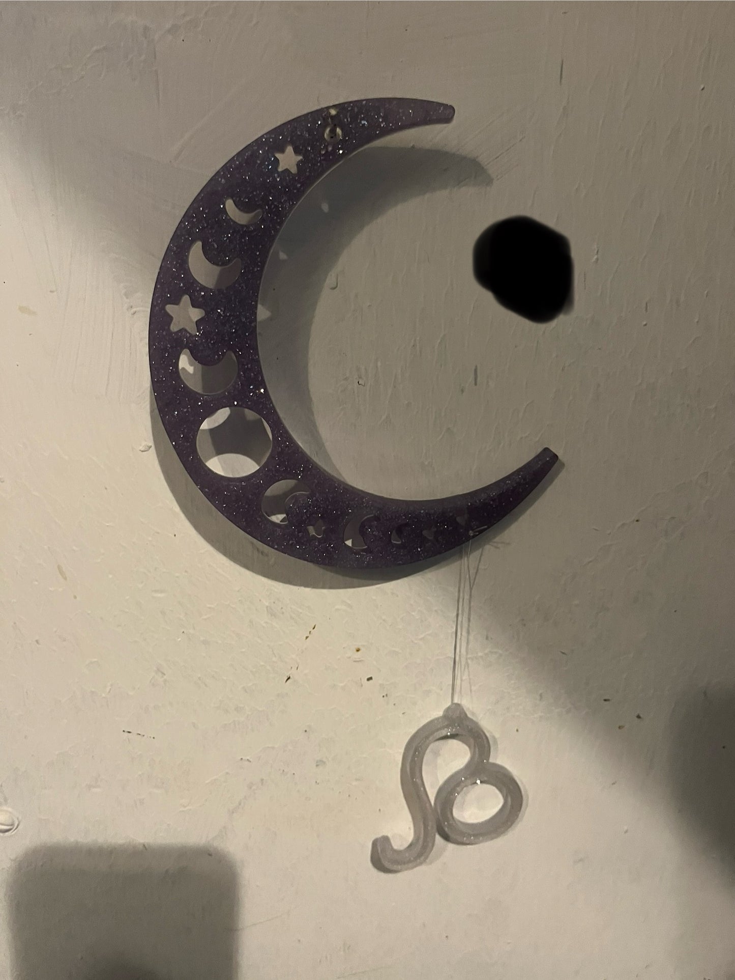 Leo horoscope hanging from the moon